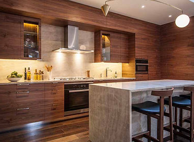 Warm wood-panelled kitchen with island and bar stools